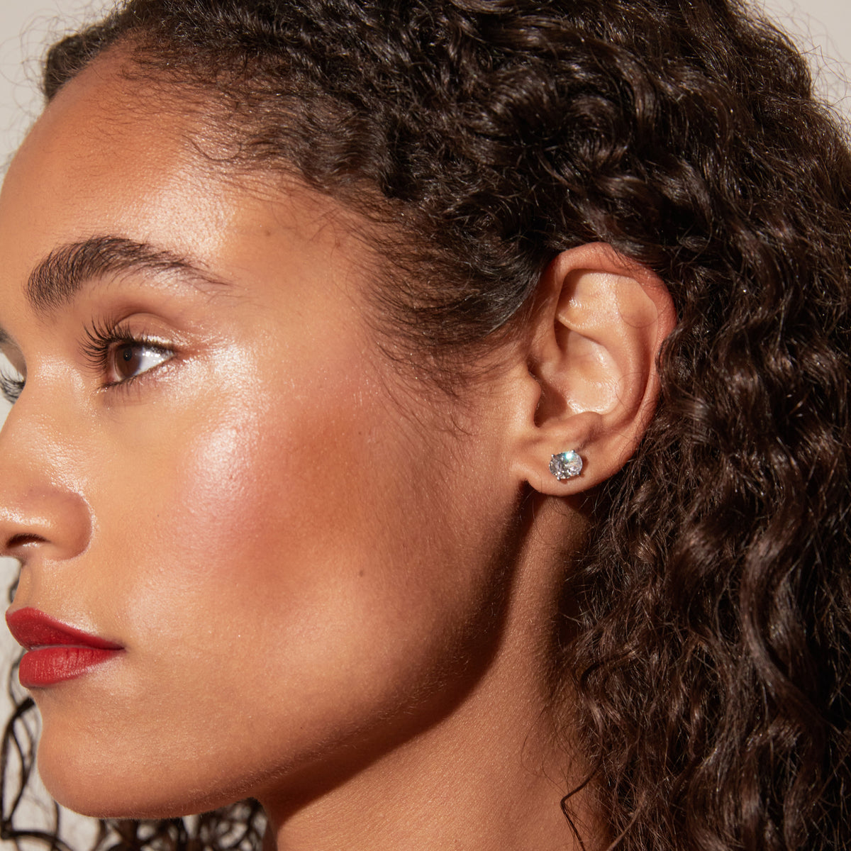 Model side profile of woman wearing diamond stud 