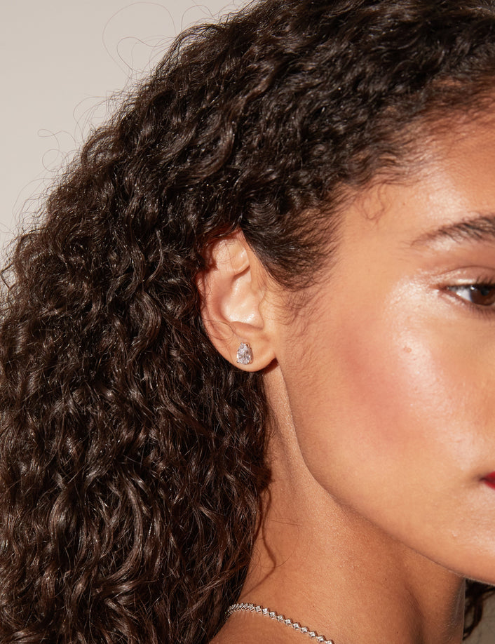Model.  side profile of woman wearing diamond earring 
