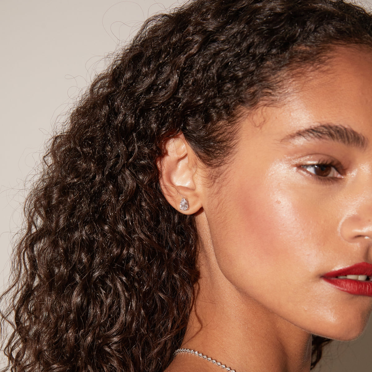 Model.  side profile of woman wearing diamond earring 