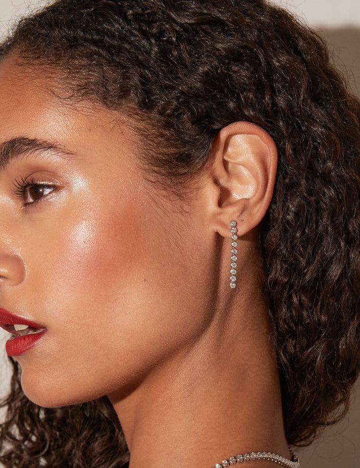 Model. Side profile woman wearing long earring 
