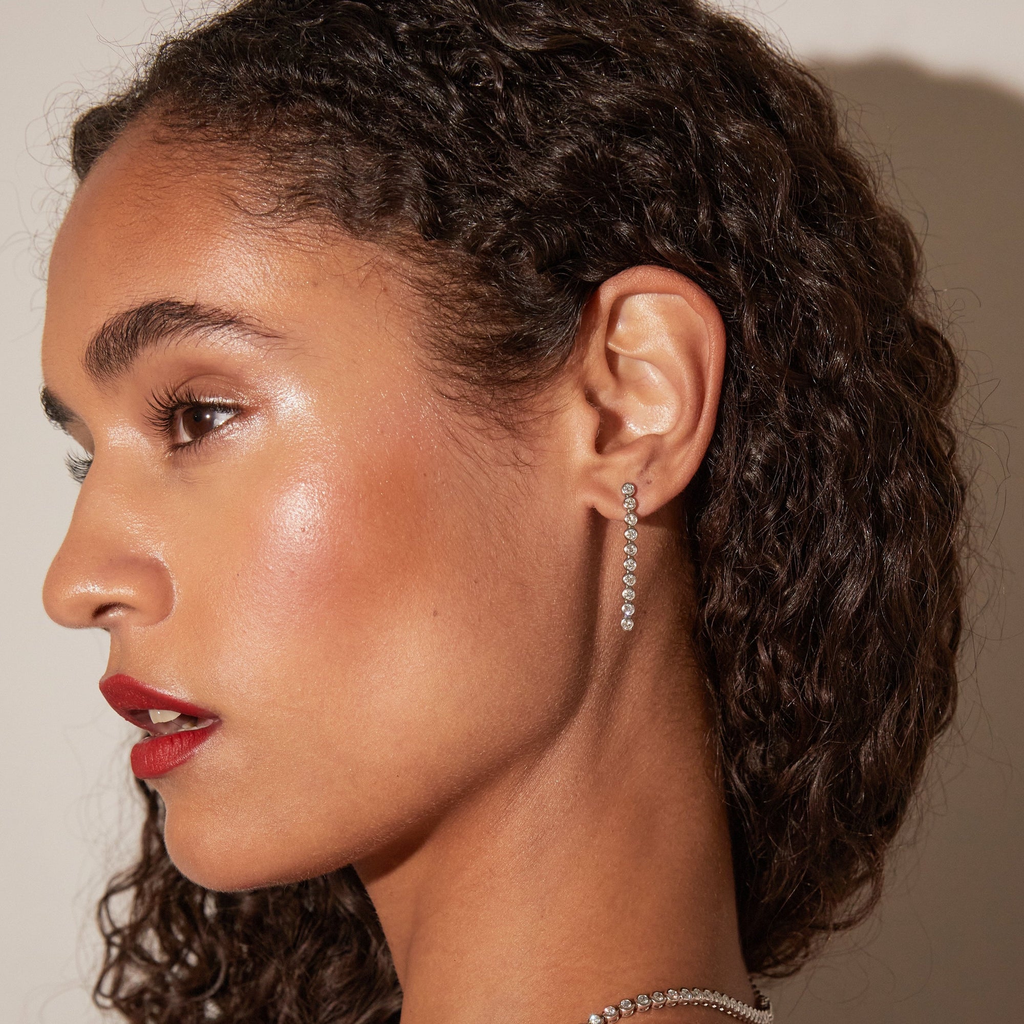 Model. Side profile woman wearing long earring 
