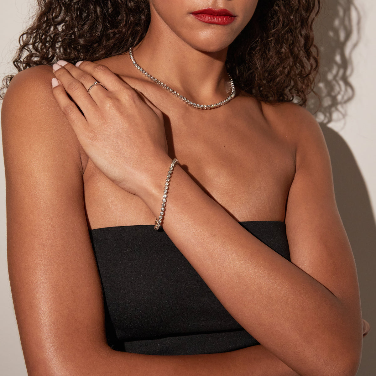 Model. Woman wearing tennis bracelet and tennis necklace 