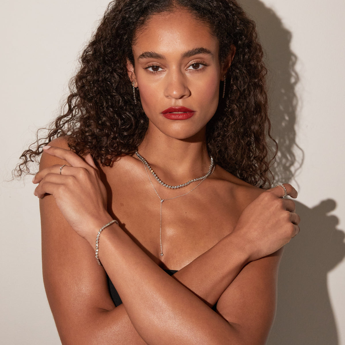Model. Woman wearing various chains and bracelets 