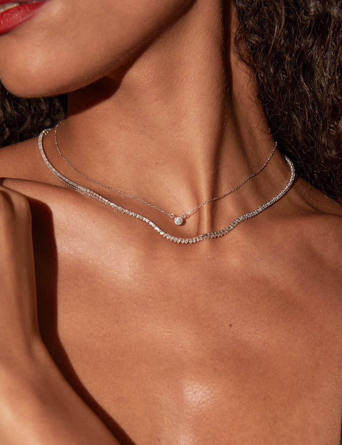 Model woman wearing two diamond necklaces 