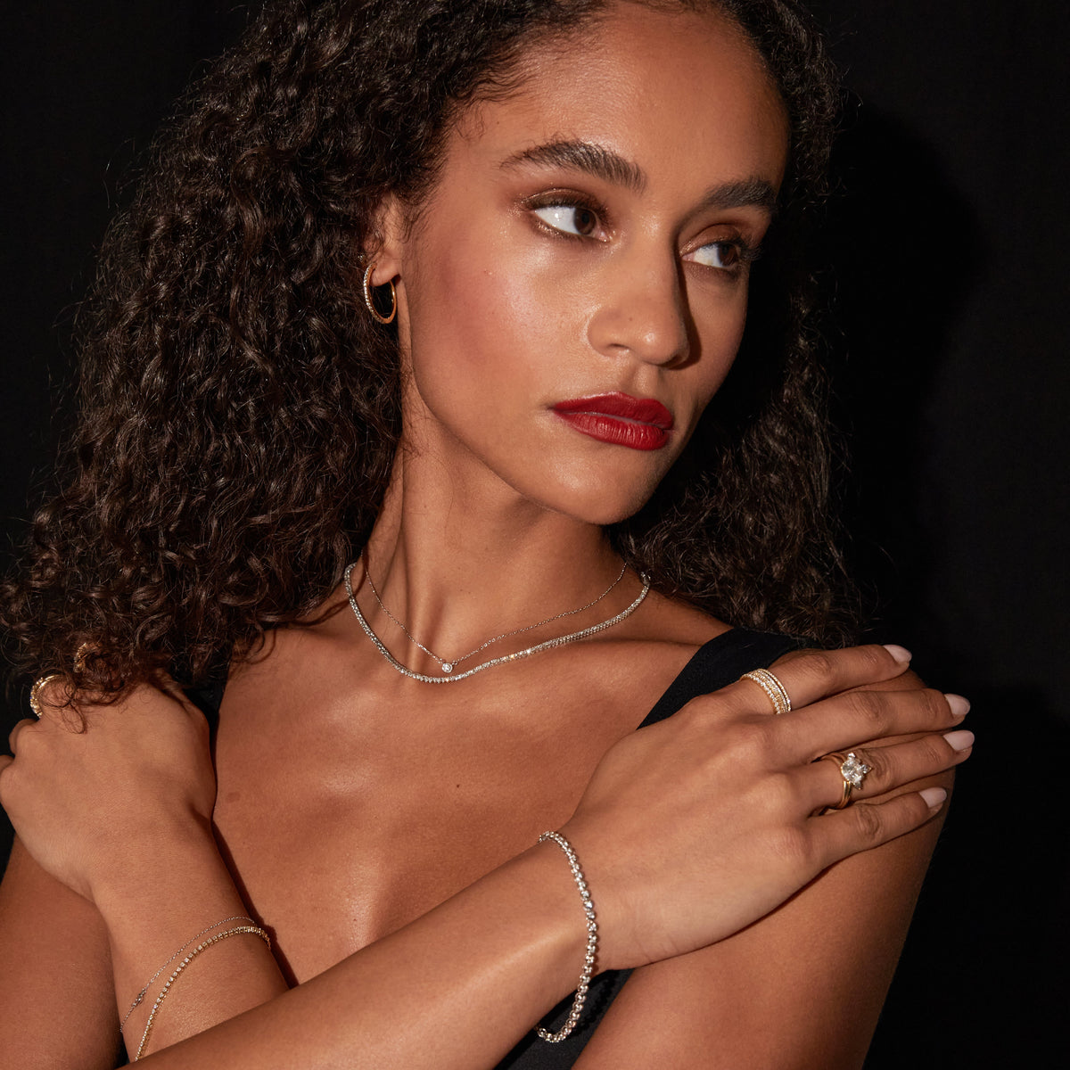 Model. Woman wearing various rings, bracelets and necklaces