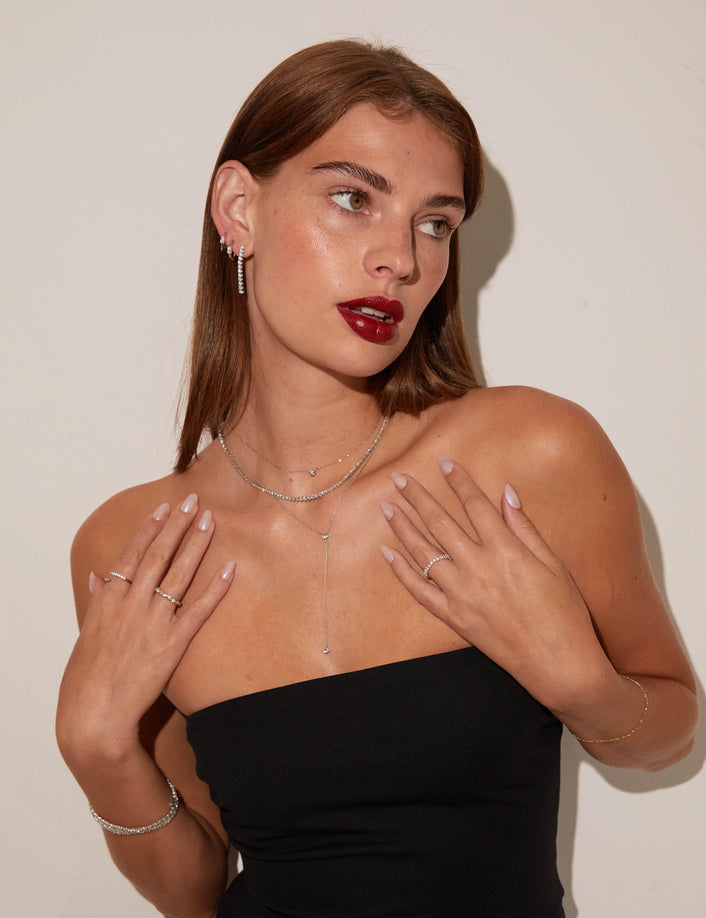 Model woman wearing different necklaces and rings 