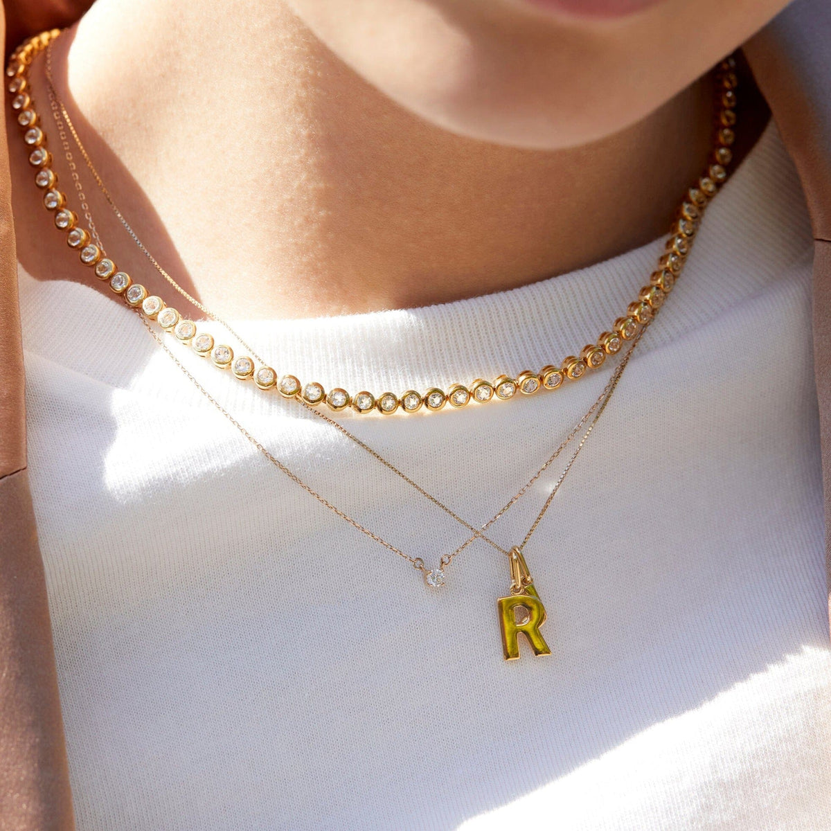 Lifestyle Model close up of woman wearing various necklaces 