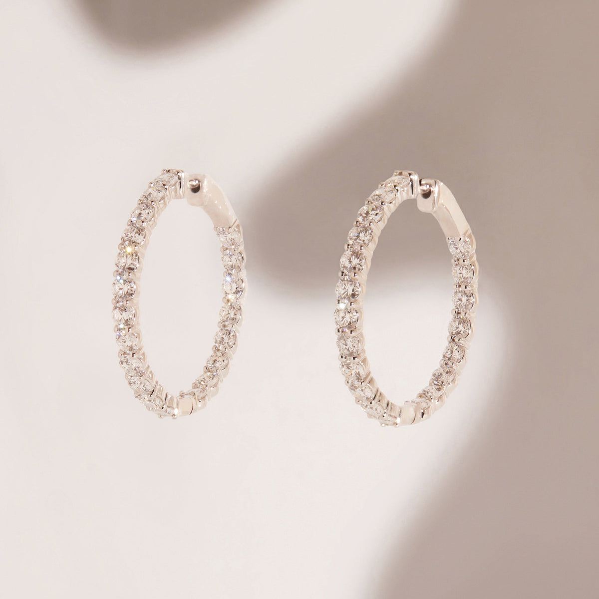 Flatlay Model. Two diamond hoop earrings 
