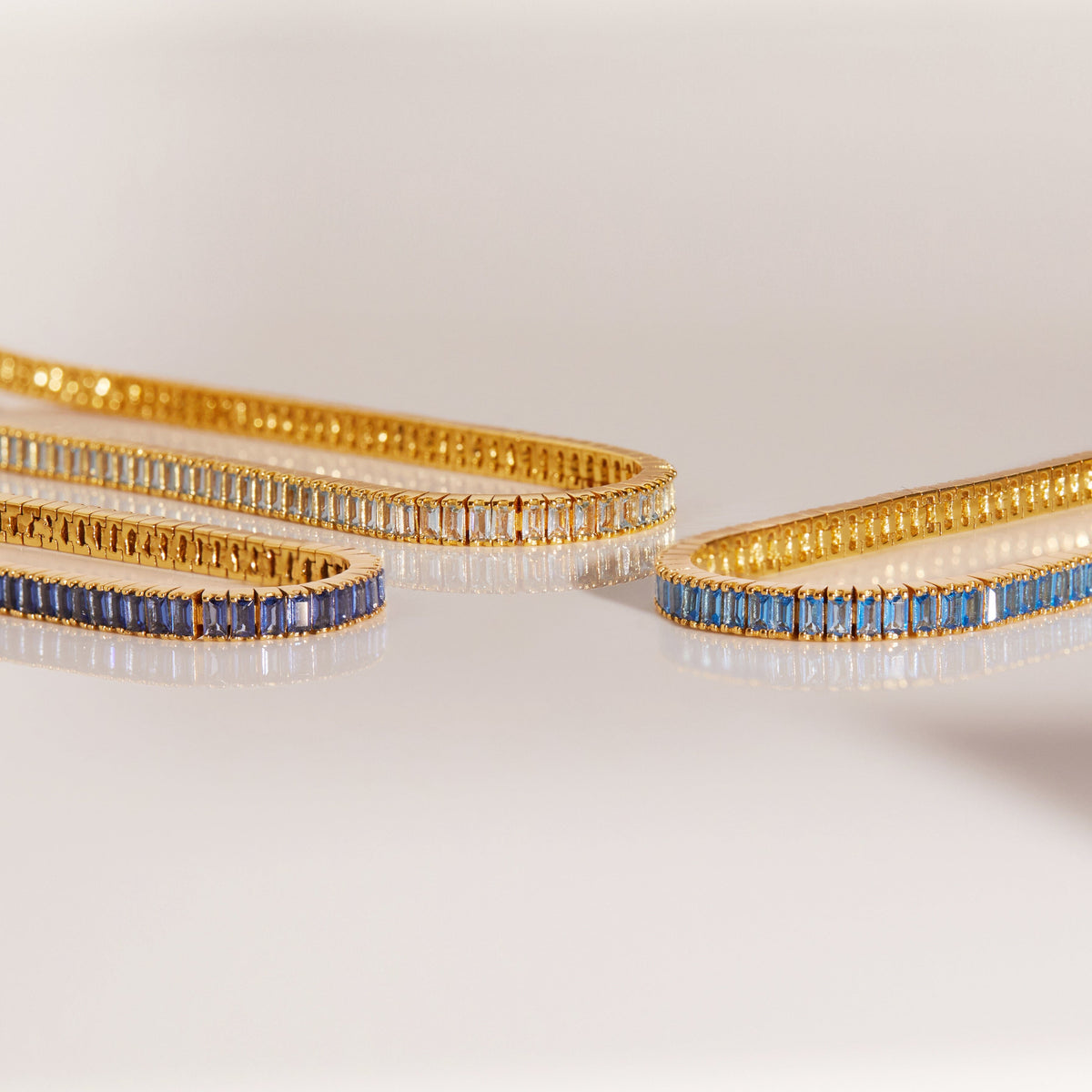Flatlay Model three bracelets on a white surface 