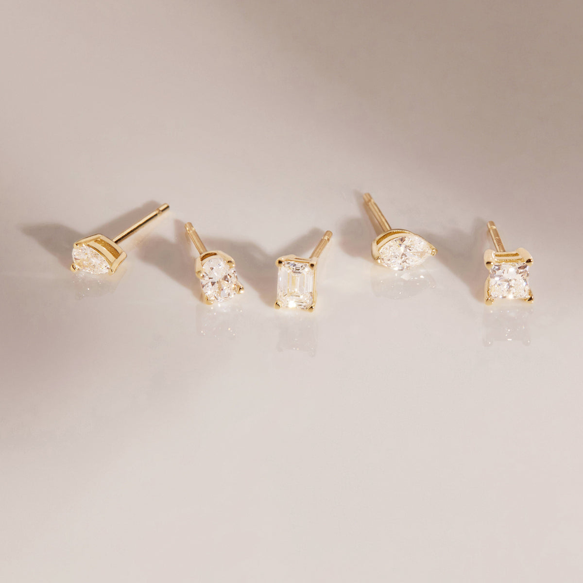 Flatlay Model.  five different diamond studs on display 