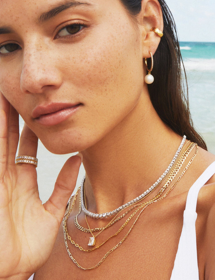 Model woman wear various jewelry at the beach 