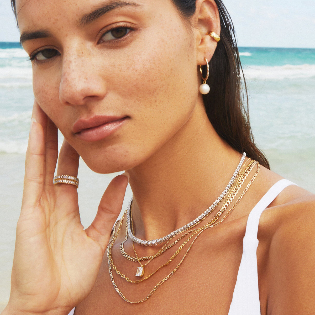 Model woman wear various jewelry at the beach 