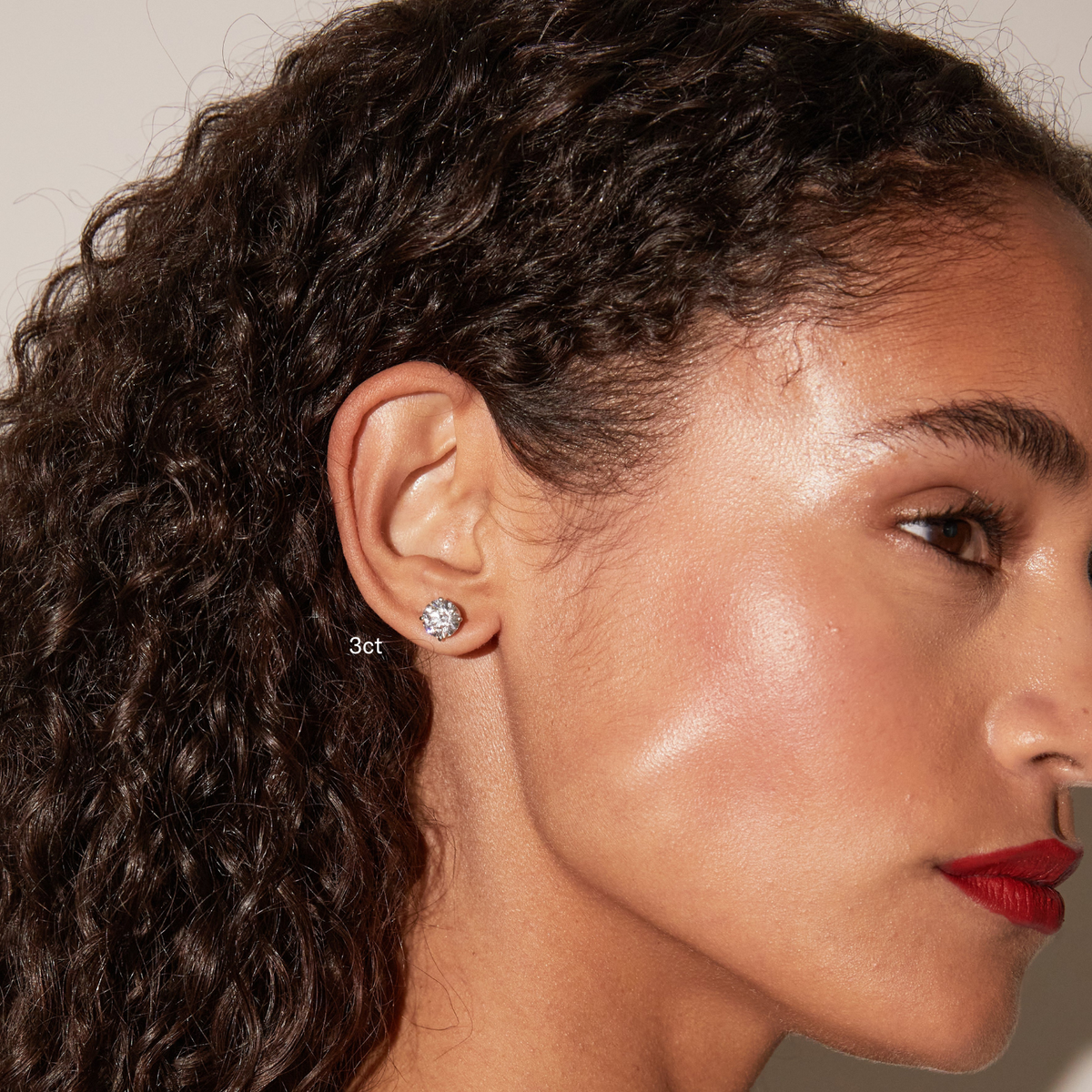 Model.  side profile of woman wearing diamond stud 