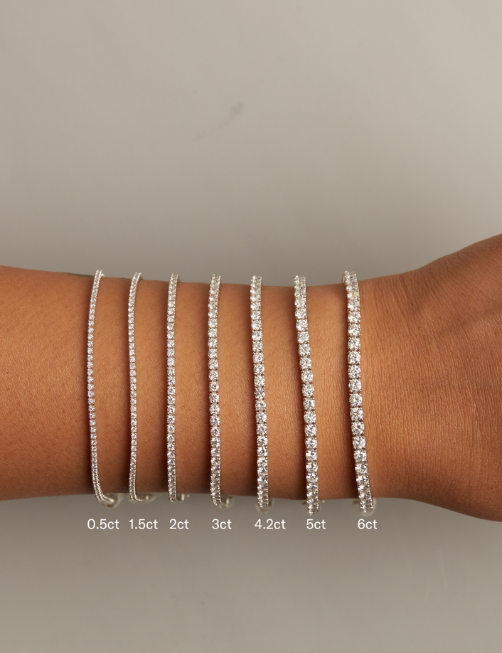 Model. Set of diamond bracelets on a wrist with weight labels.
