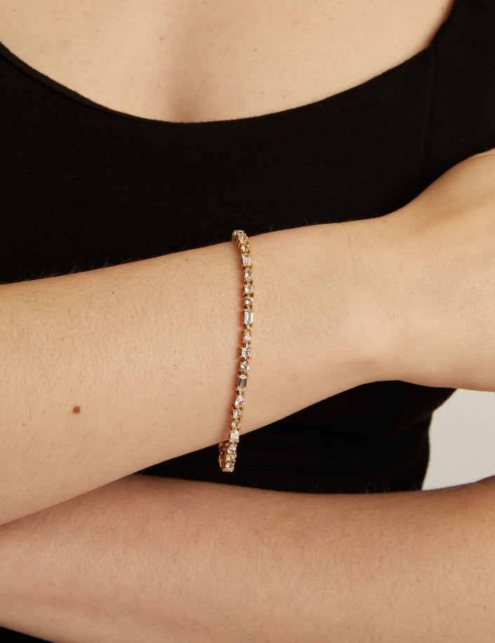 Close up of a mixed shape tennis bracelet on wrist