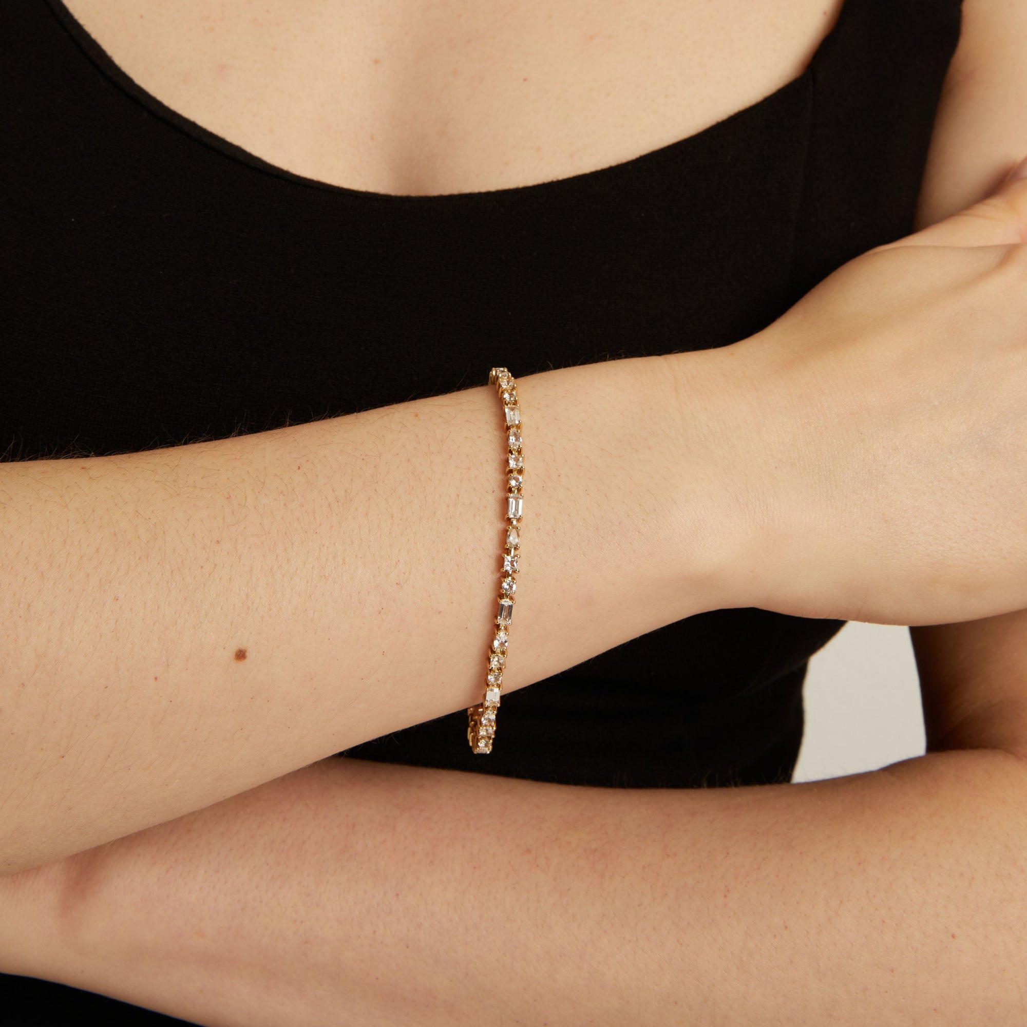 Close up of a mixed shape tennis bracelet on wrist