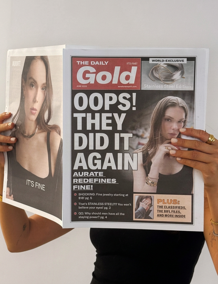 Model. Woman holding a tabloid over her face on a neutral background.