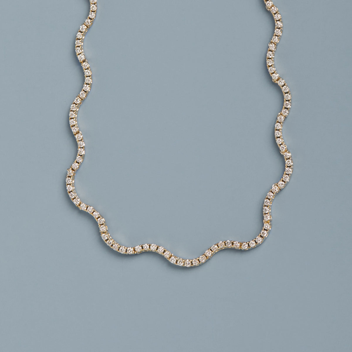 Model. Diamond necklace on a light blue background