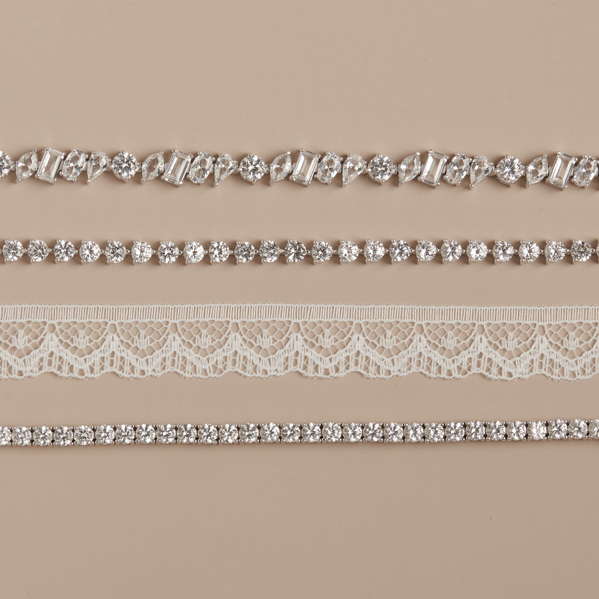 Model. Collection of lace and rhinestone trim on a beige background