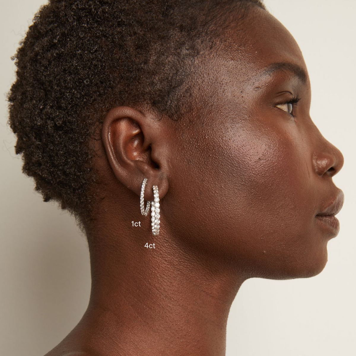 Model. Woman wearing diamond hoop earrings