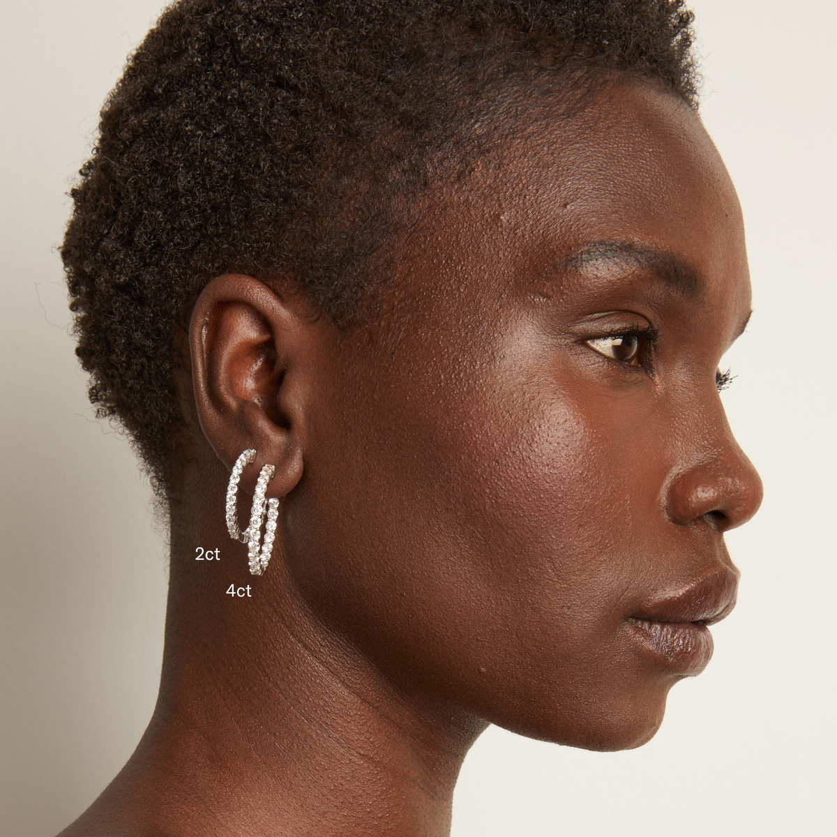Model. Woman wearing diamond hoop earrings