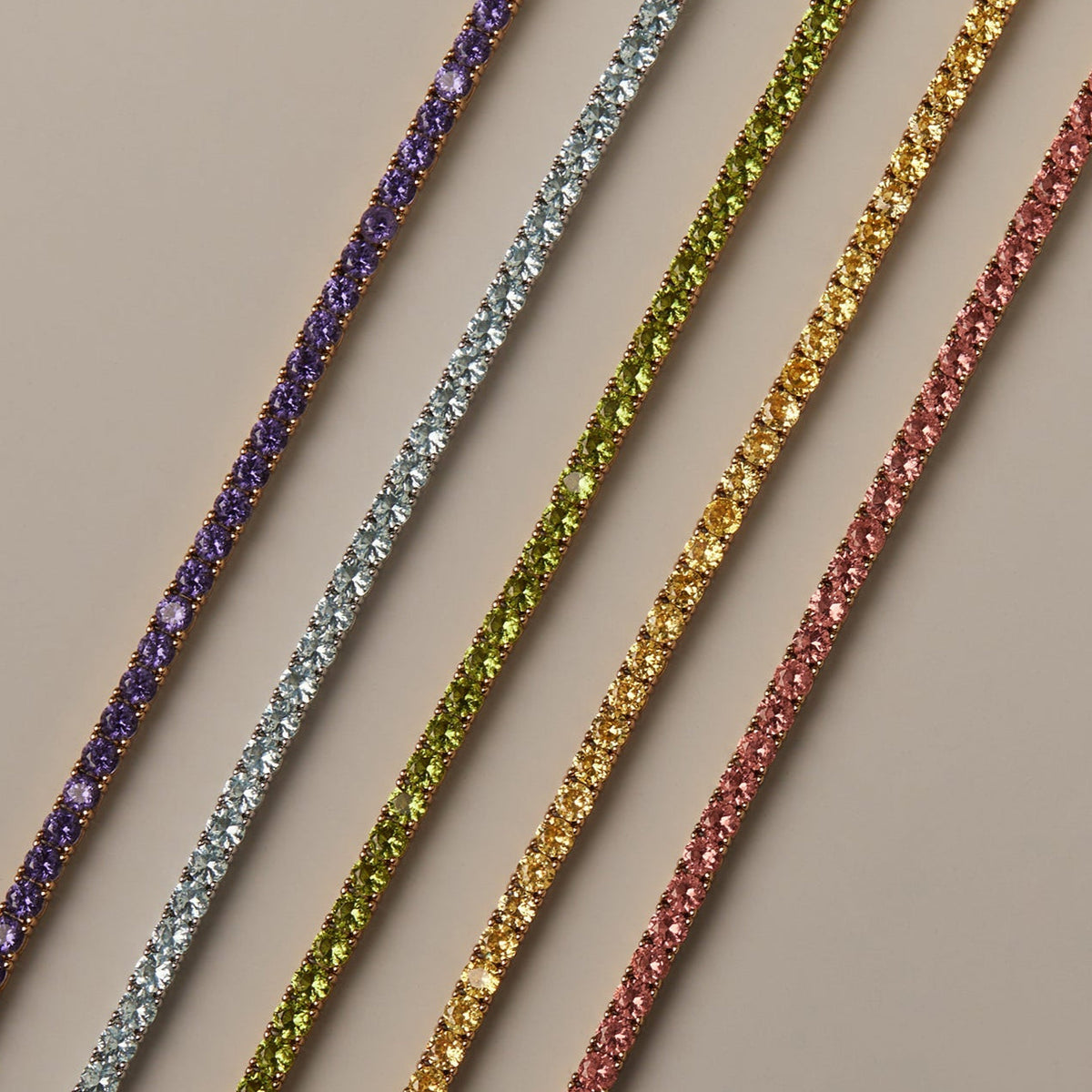 Model Set of four colorful bracelets on a beige background