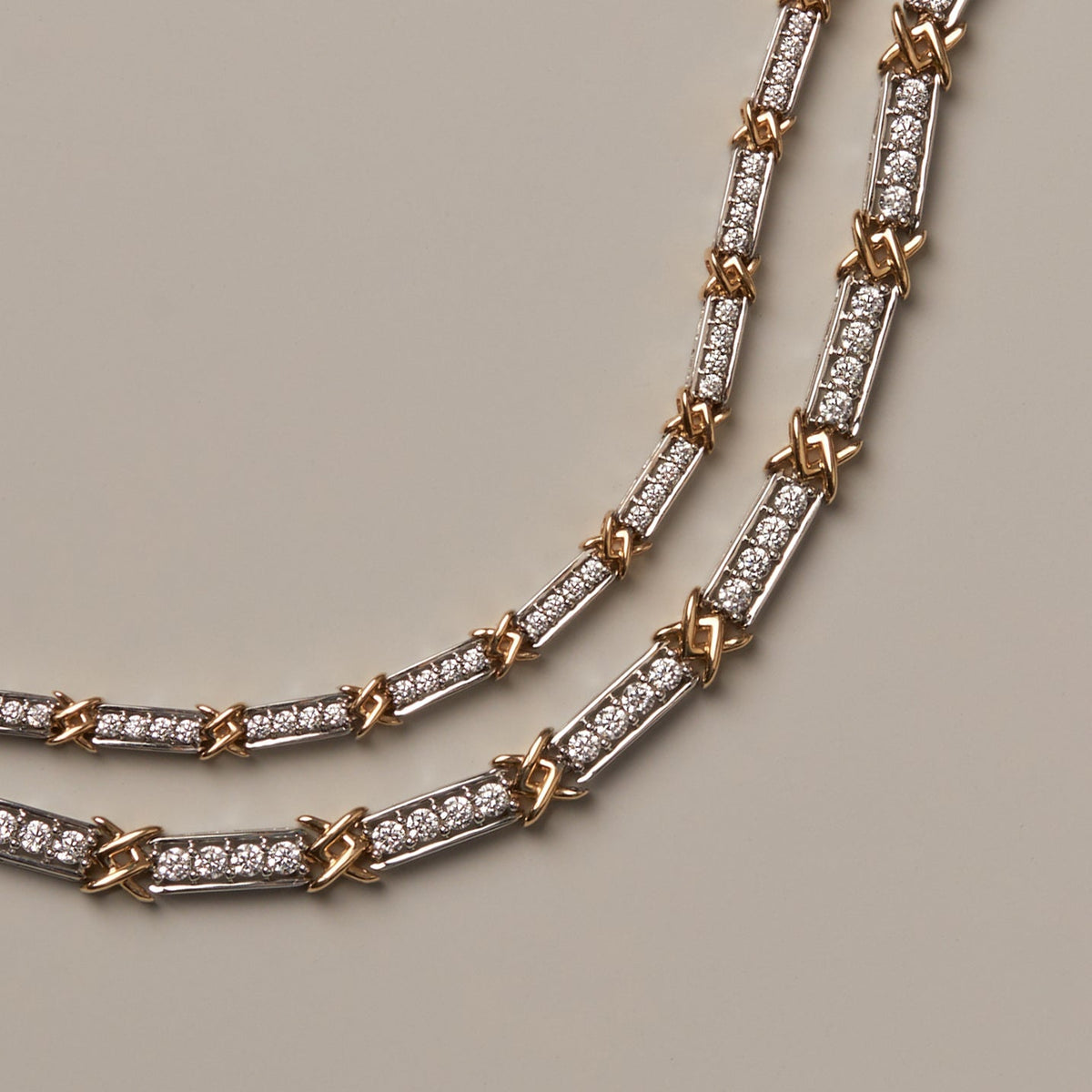 Flatlay Model. Gold and silver chain necklace on a neutral background