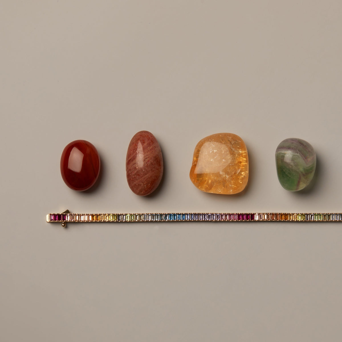 Flatlay Model. Set of colorful stones on a ruler against a beige background