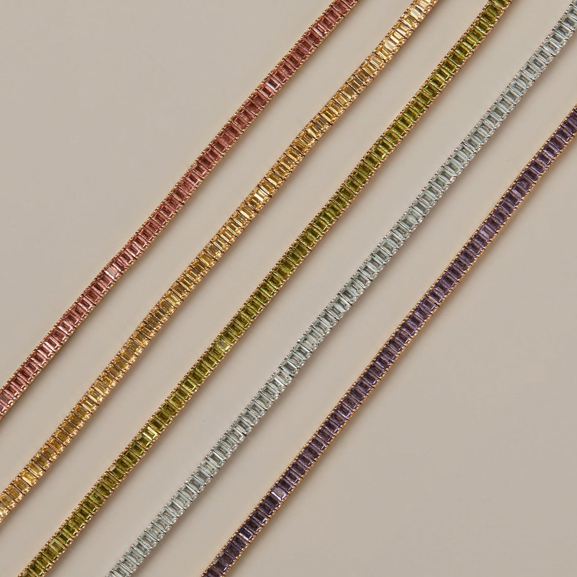Model. Set of gold and silver bracelets on a beige background