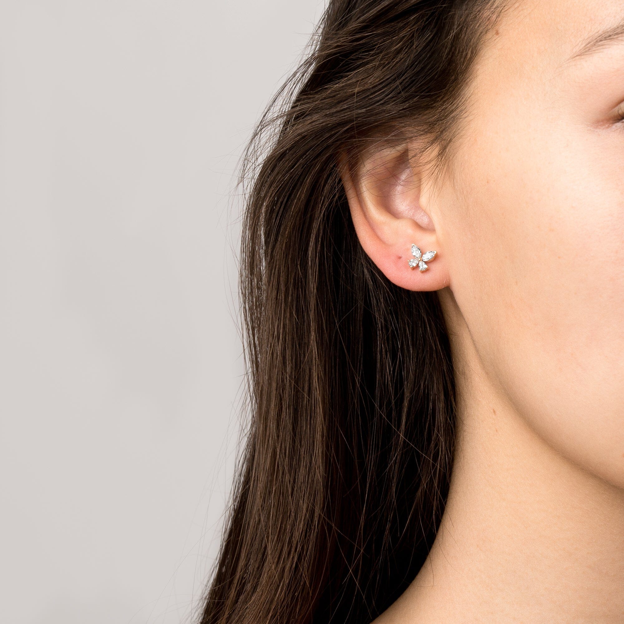 Model Close up of woman wearing a butterfly earring 