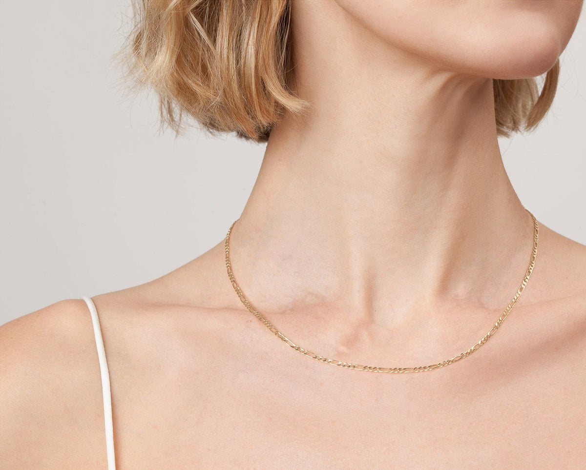 Model. Model. Close up of woman wearing gold chain necklace 