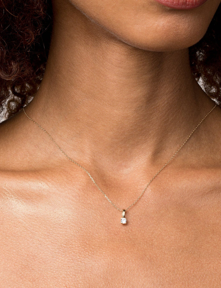Woman wearing diamond pendant necklace 