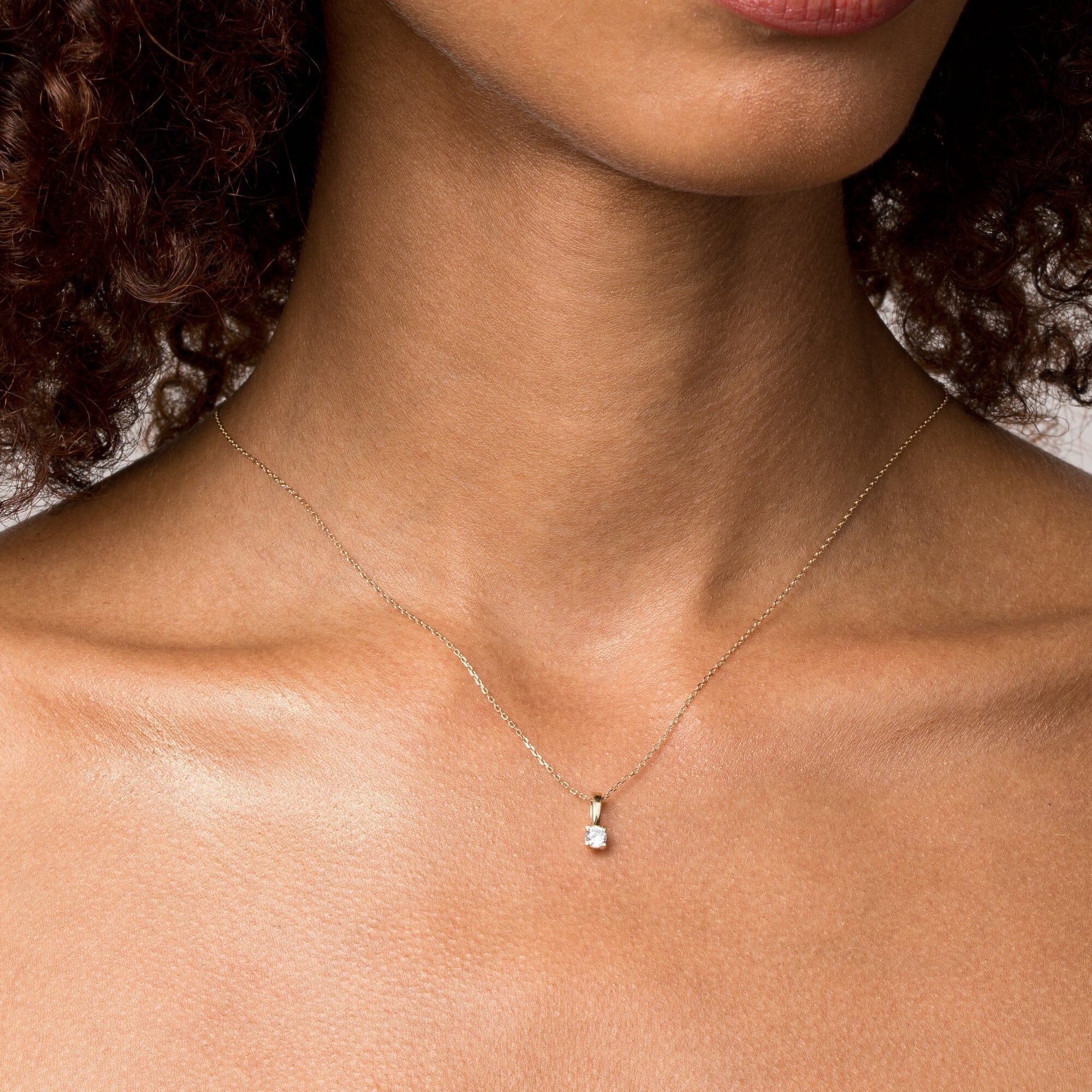Woman wearing diamond pendant necklace 
