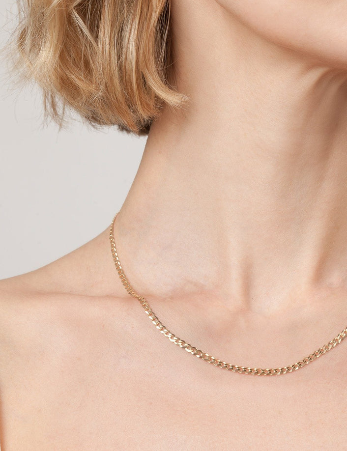 Model. Close up of woman wearing gold chain necklace