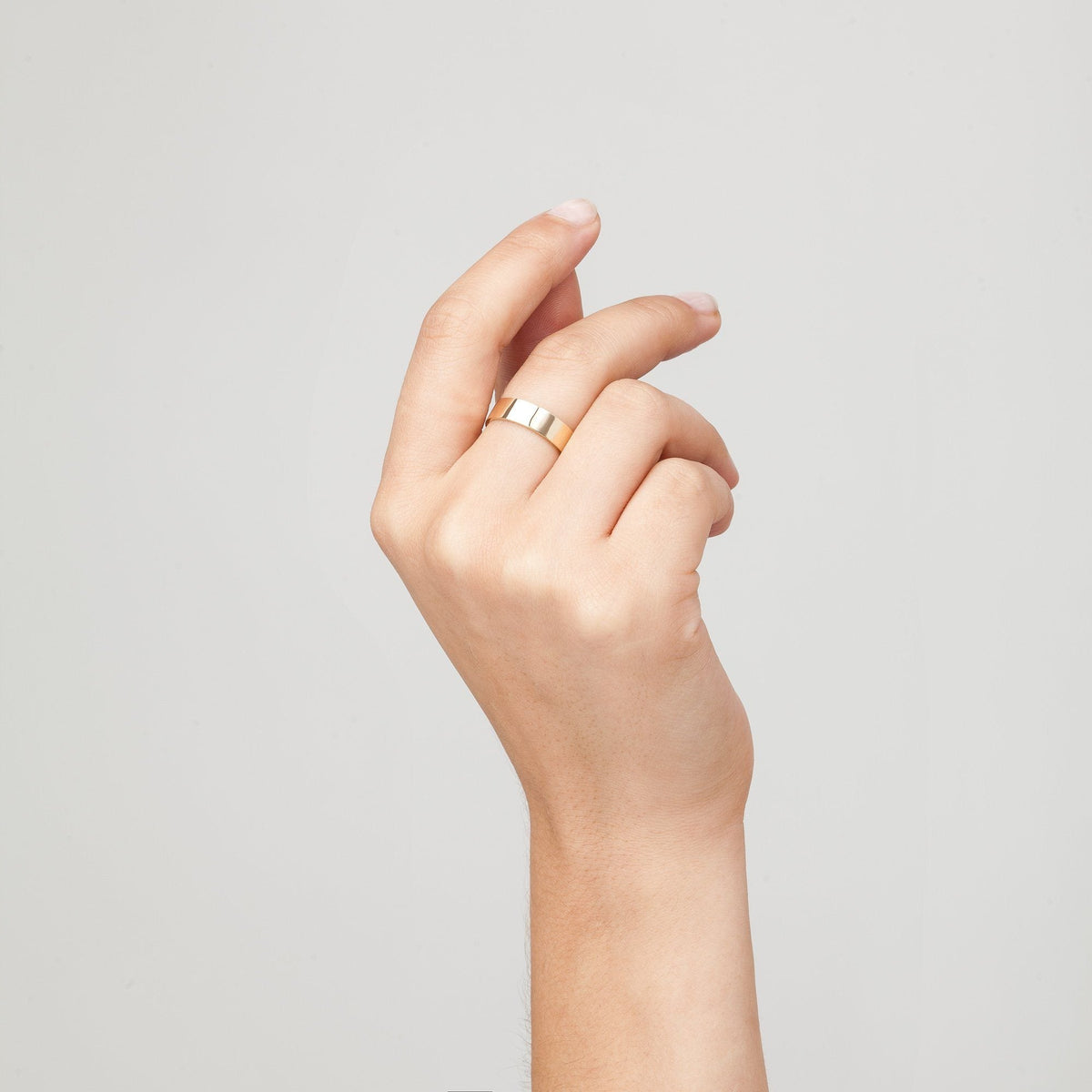 Close up of woman's hand with gold ring