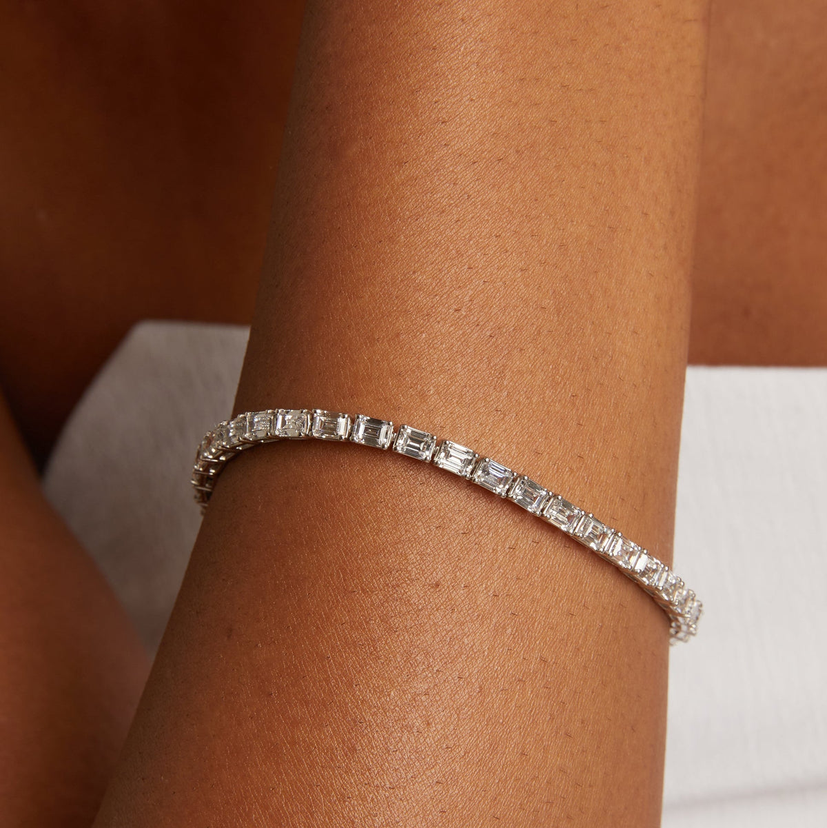 Model. Silver bracelet on a wrist with a neutral background