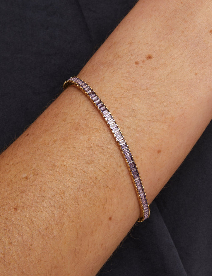 Bracelet on a wrist with a dark background