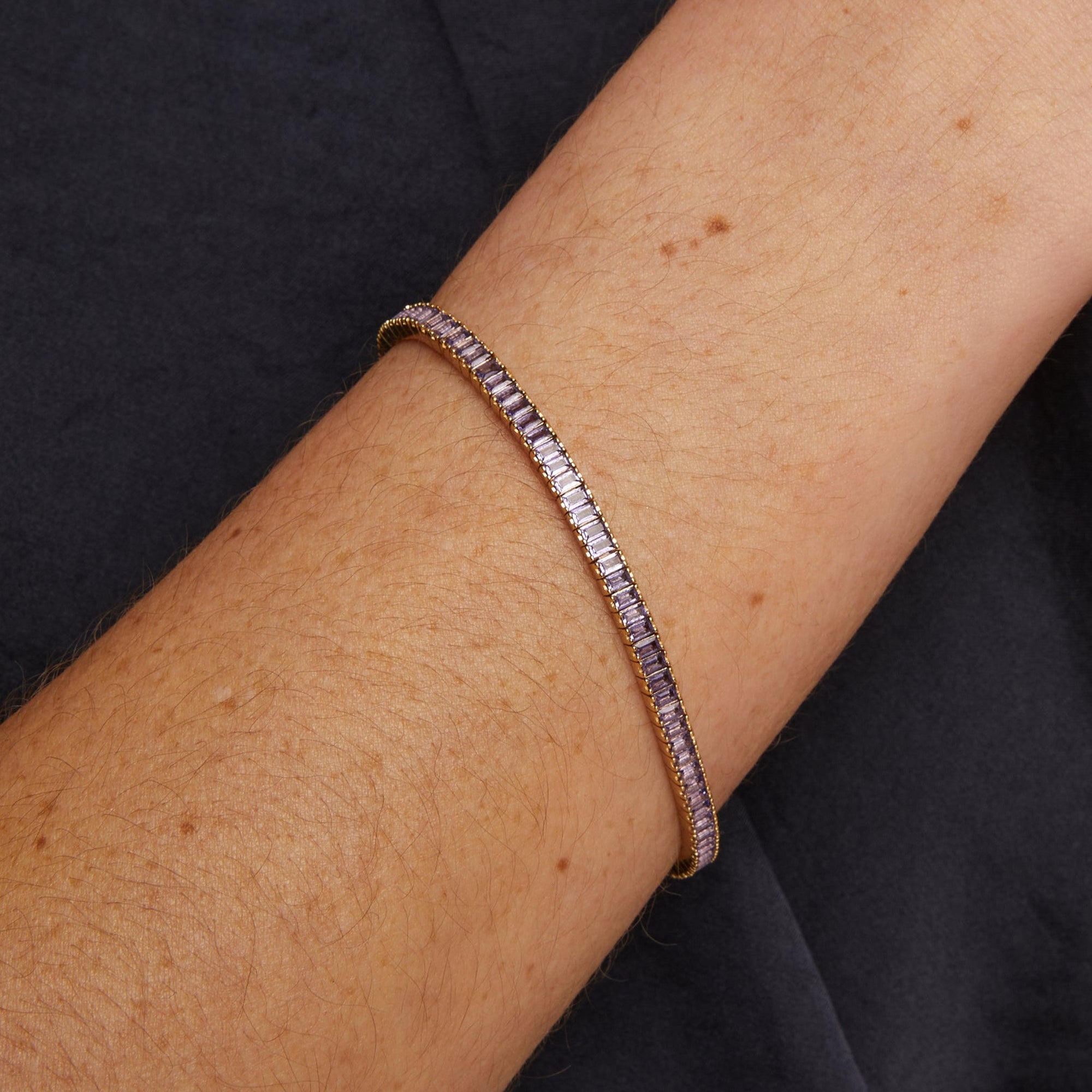Bracelet on a wrist with a dark background