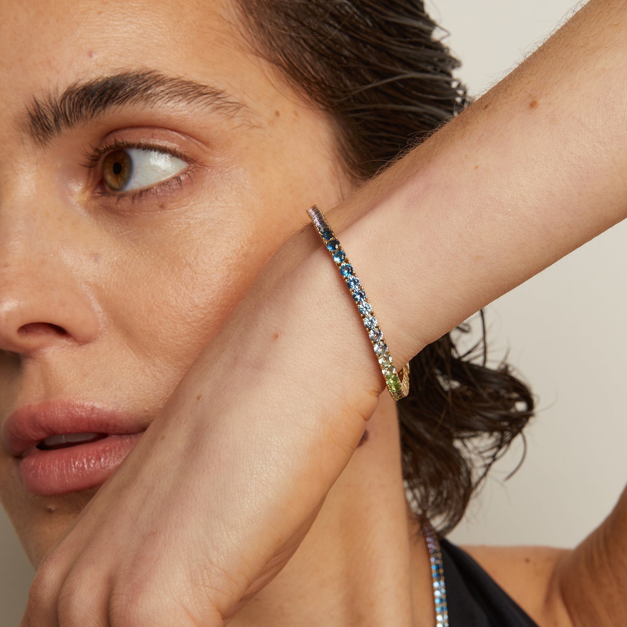 Model. Close-up of a woman wearing colorful beaded bracelets on her wrist.
