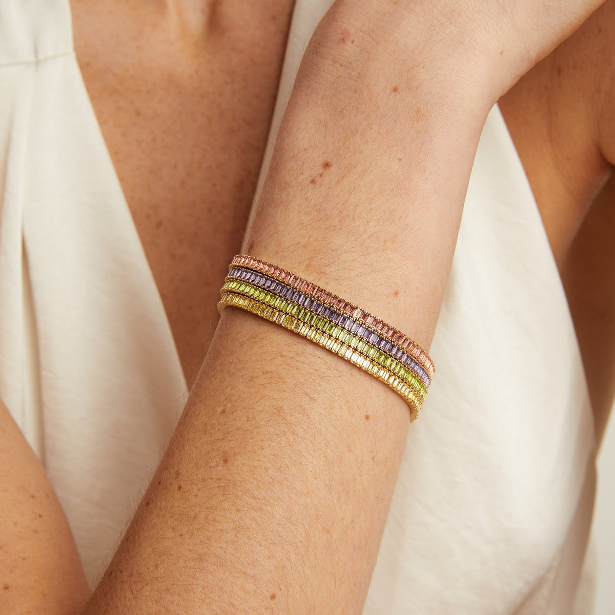 Model. Multicolored bracelet on a person's wrist with a white background