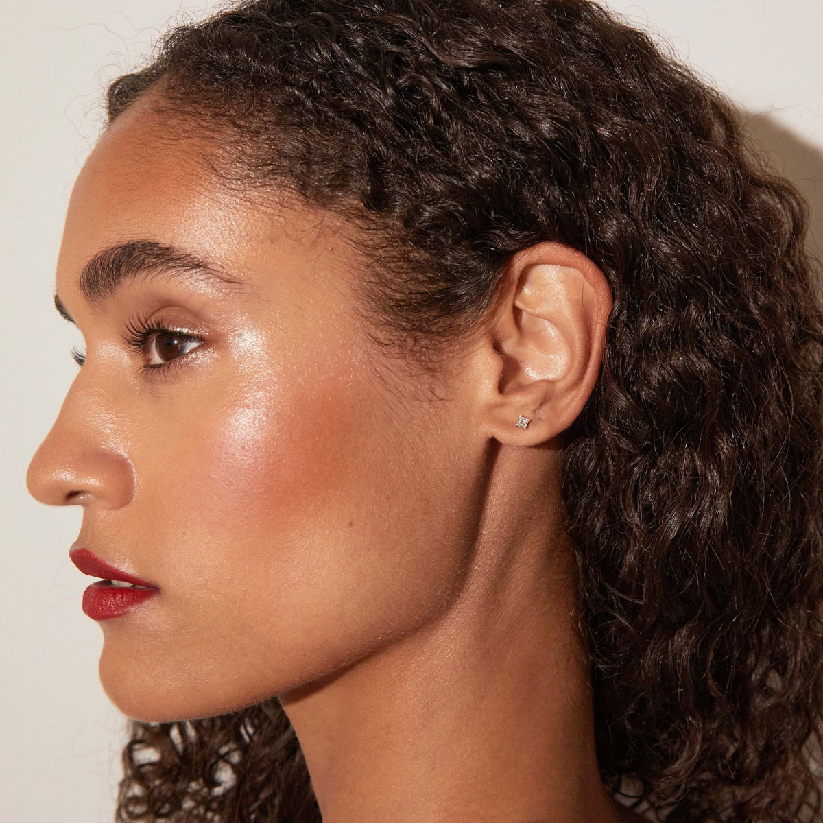 Model woman wearing small diamond stud 